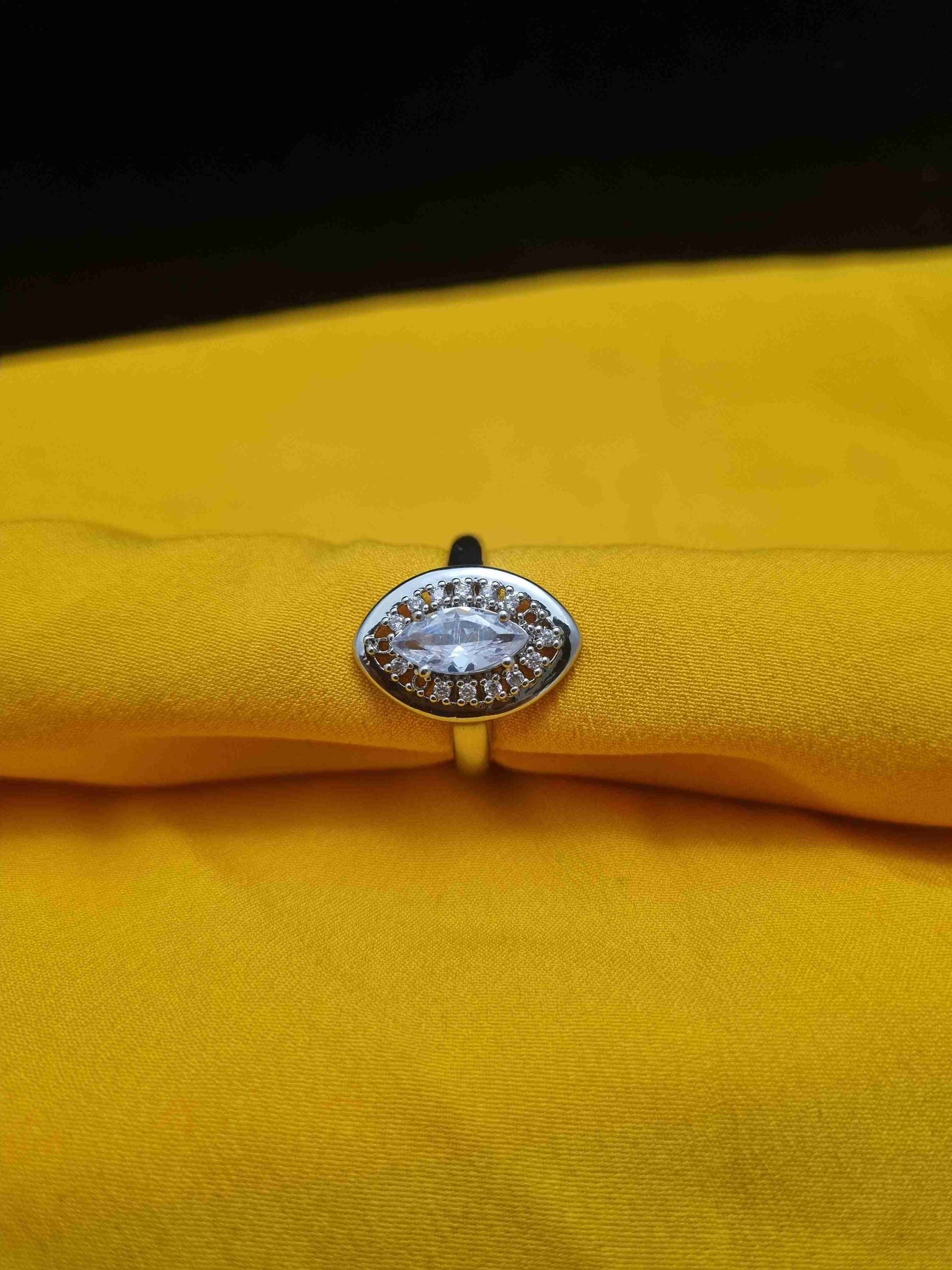 Elegant gold ring with an oval crystal centerpiece, perfect for weddings and formal events.
