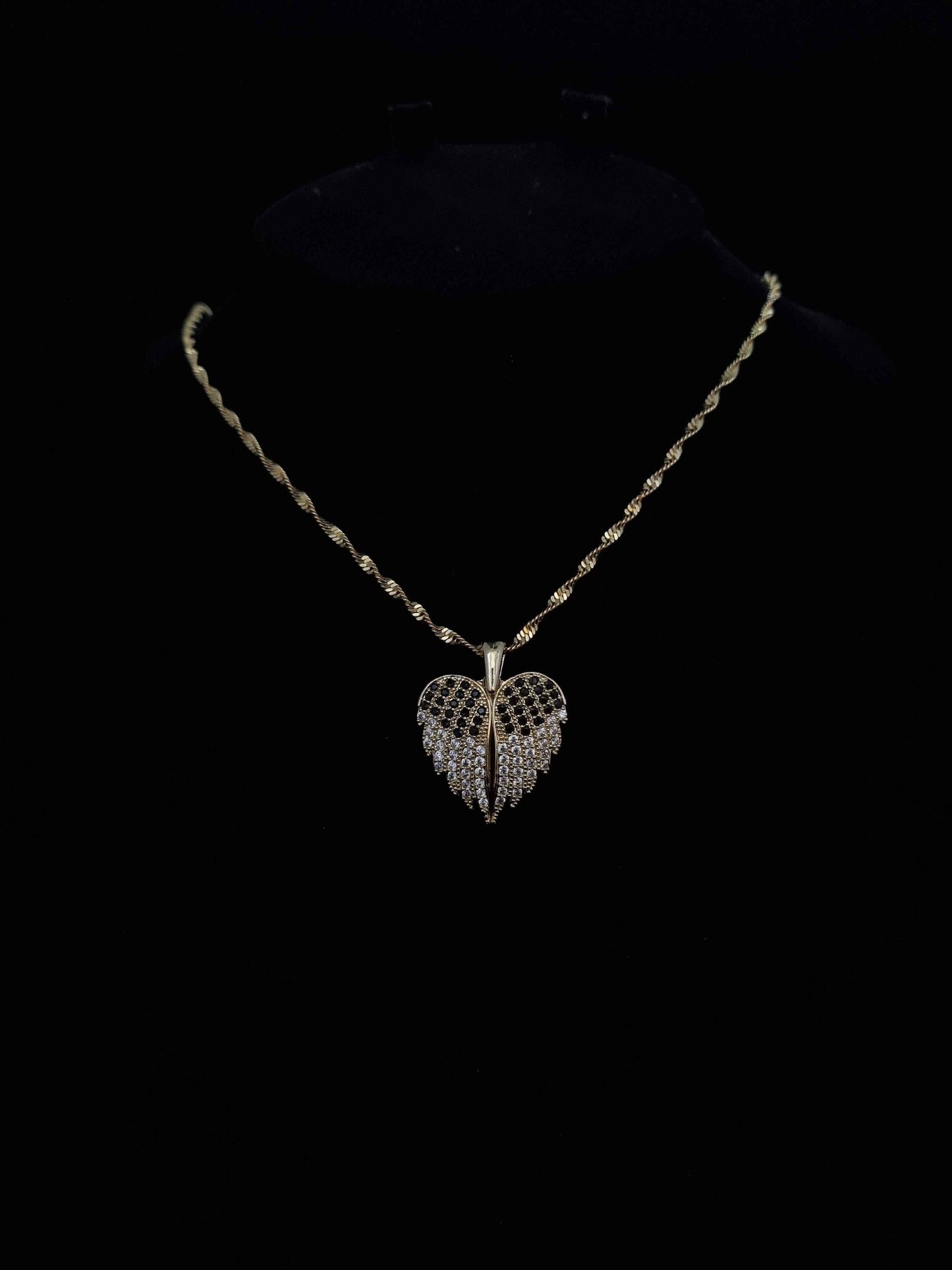 Delicate golden necklace with a sparkling leaf-shaped pendant.