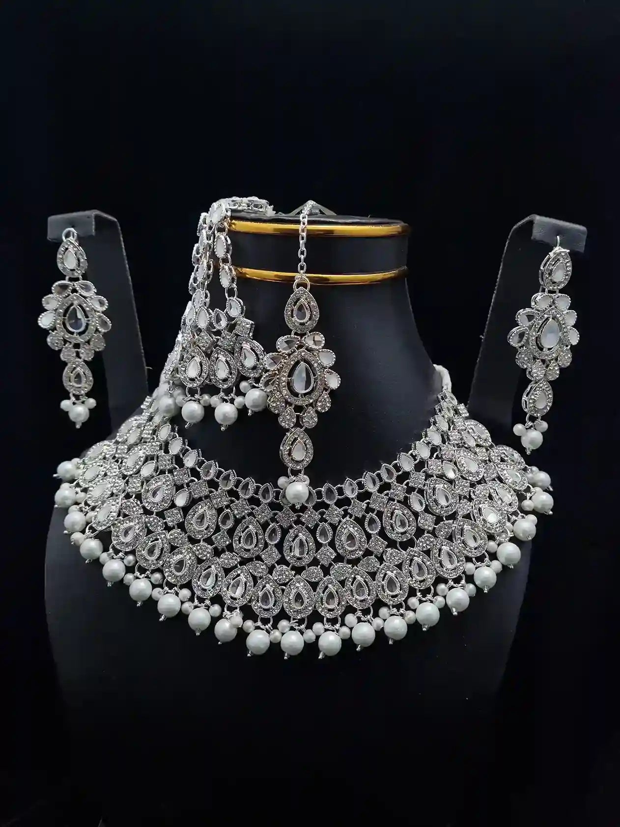 Silver bridal necklace set featuring a stunning necklace with pearl and crystal detailing, paired with elegant earrings for weddings.