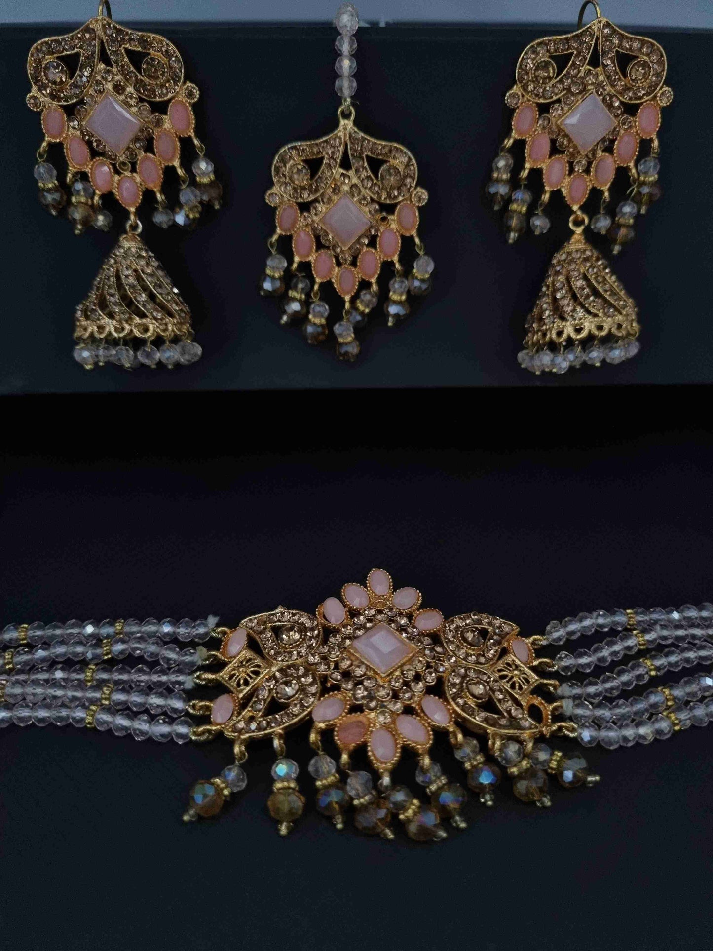 Elegant pearl and Kundan bridal jewelry set with a choker necklace, matching earrings, and intricate gold-plated detailing.

