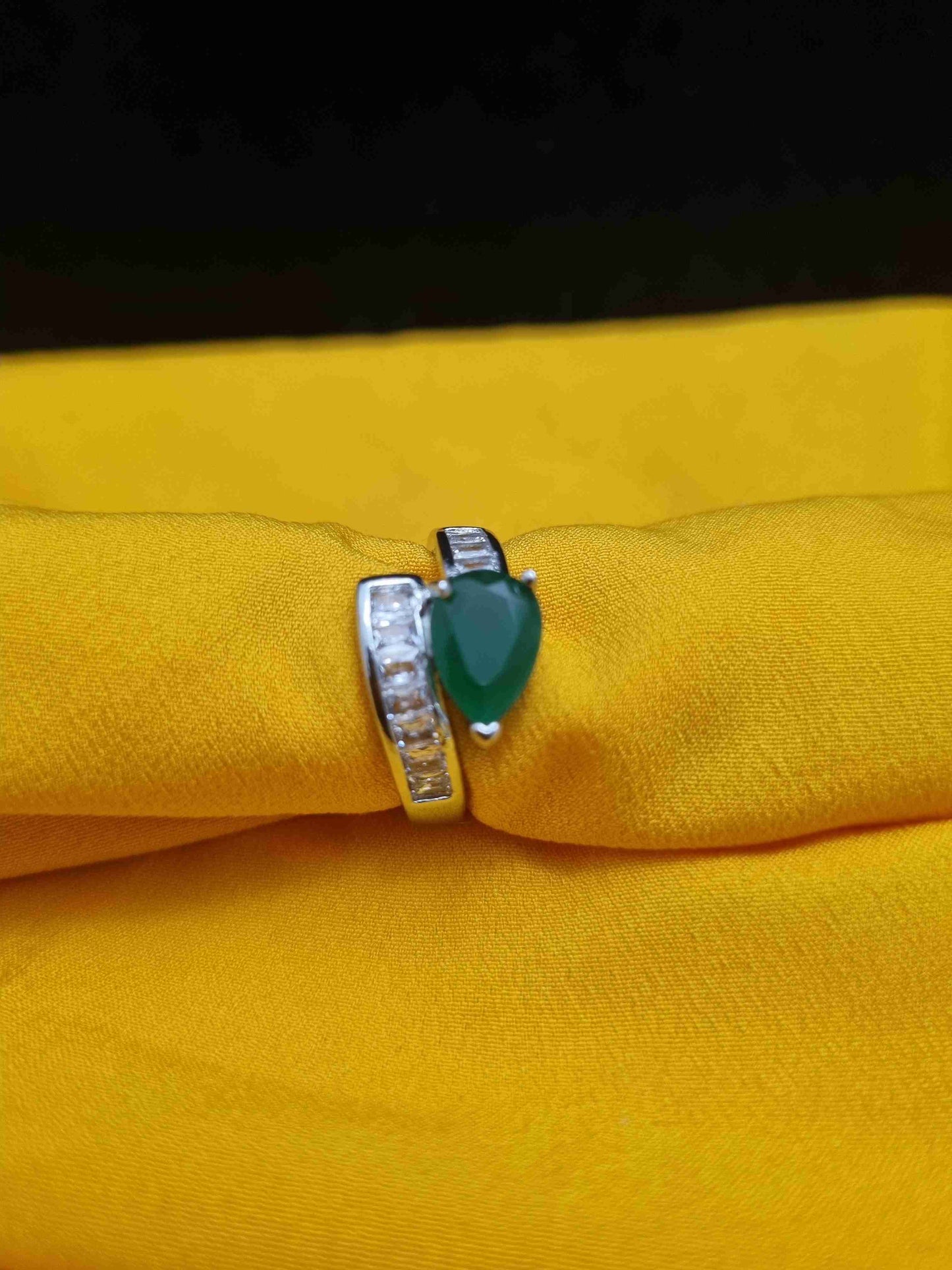 Elegant silver ring with a green stone centerpiece, perfect for events and daily wear.