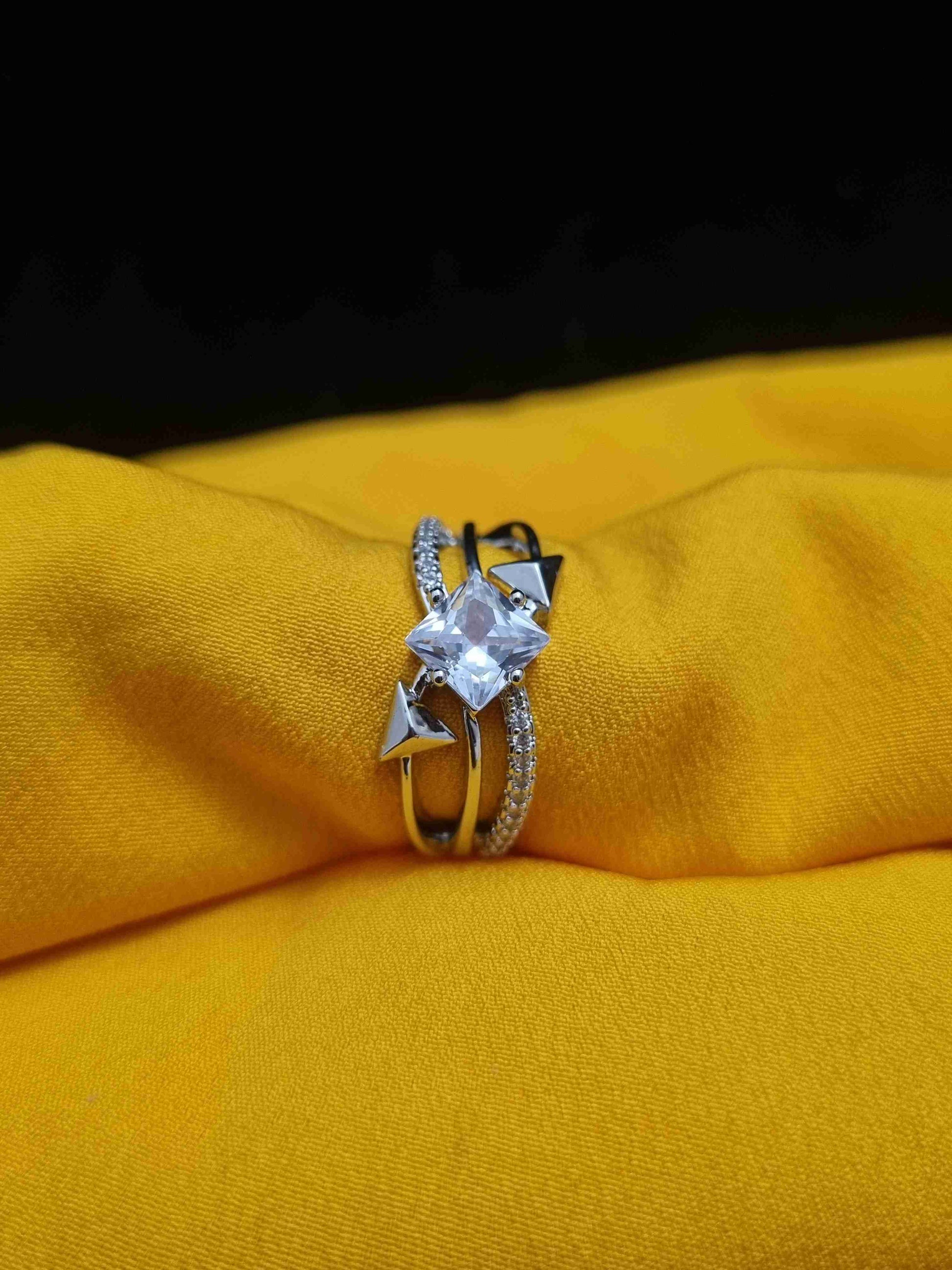 Elegant silver ring featuring a diamond-style centerpiece with modern geometric accents.